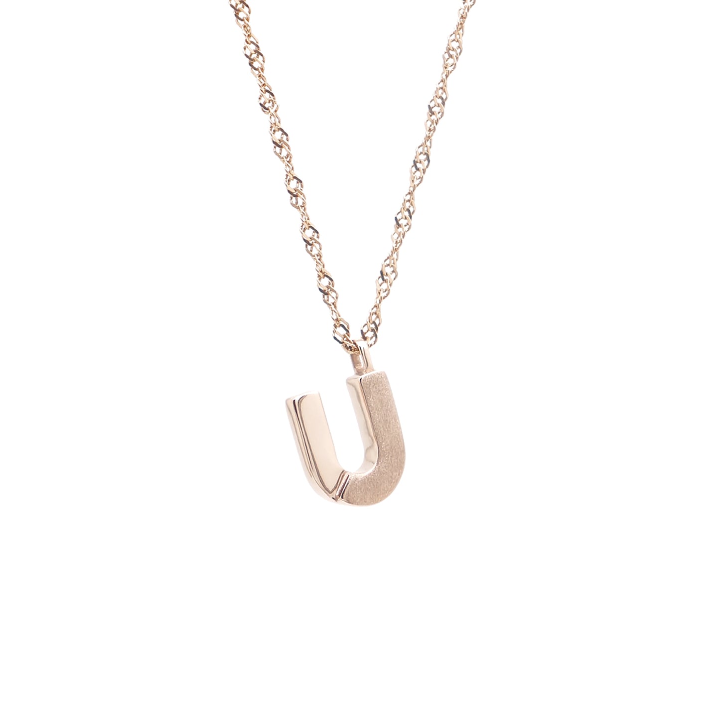A red gold chain necklace with a letter u pendant.