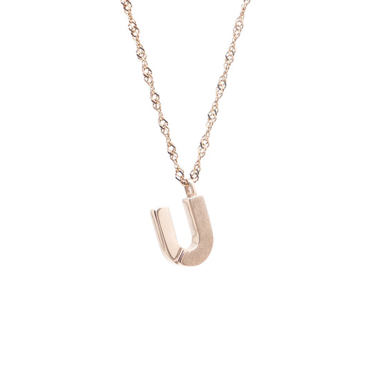 A red gold chain necklace with a letter u pendant.