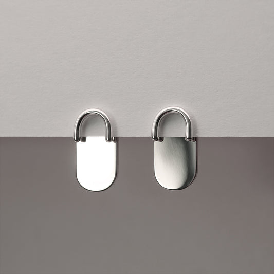 A front view of two minimalistic design silver earrings.