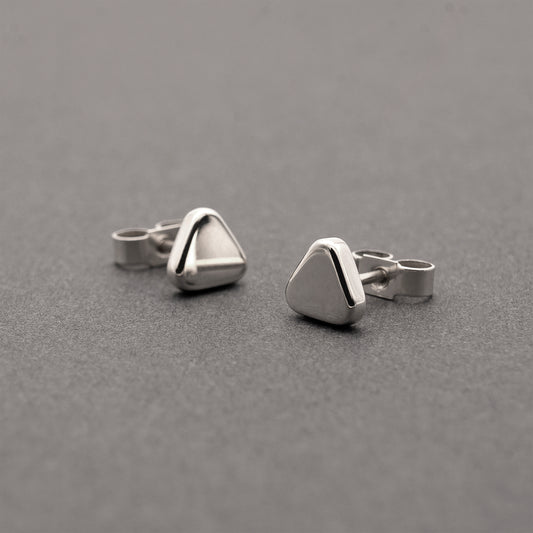 Two small minimalist design silver earrings in a soft triangular shape.