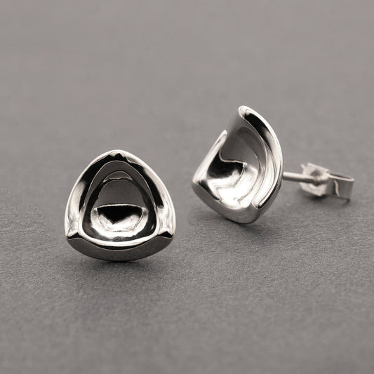 Two silver earrings in a minimalist, organic shape.